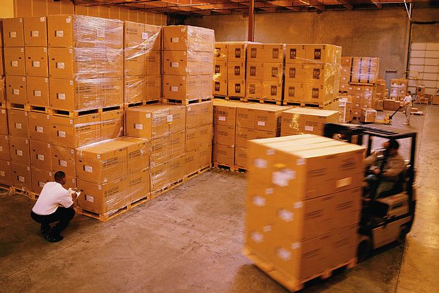 Forklift Moving Boxes in Warehouse