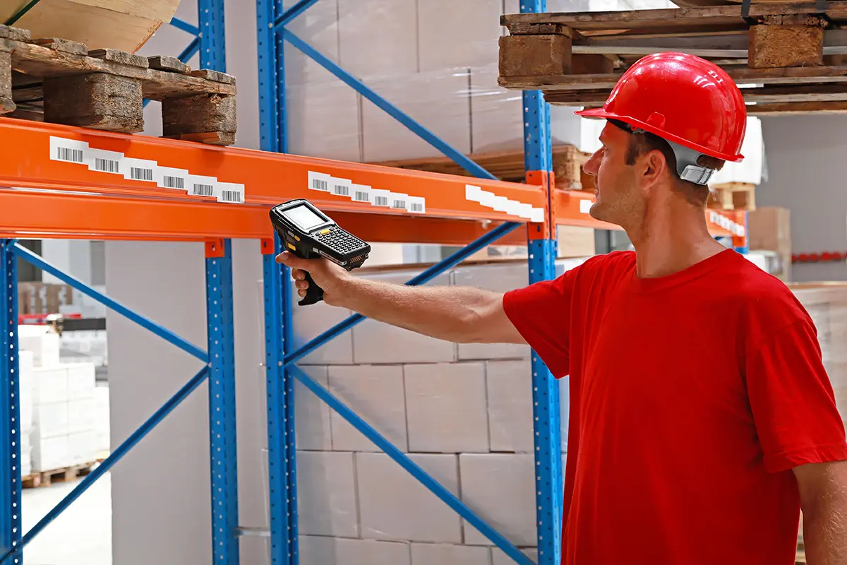 Worker scanning a warehouse rack label