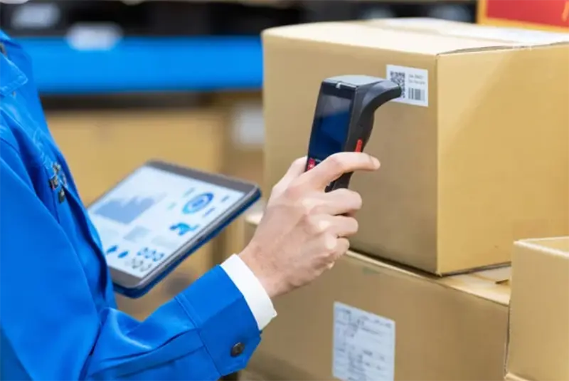 Barcode scanner in use in a warehousing facility.